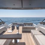 Bluegame 54 luxury yacht exterior salon view, showcasing panoramic seating area with Mediterranean Sea views