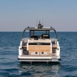 Bluegame 54 luxury yacht rear view, showcasing expansive aft deck and water access platform